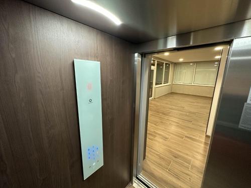 a door to a room with a elevator and a hallway at ACM Premium 3 camere Apartament elegant in Voluntari