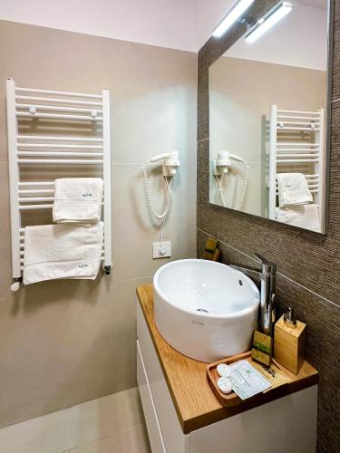a bathroom with a sink and a mirror at ACM Premium 3 camere Apartament elegant in Voluntari