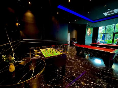 a room with a pool table and a ping pong table sidx sidx at Star Residence Suite KLCC in Kuala Lumpur