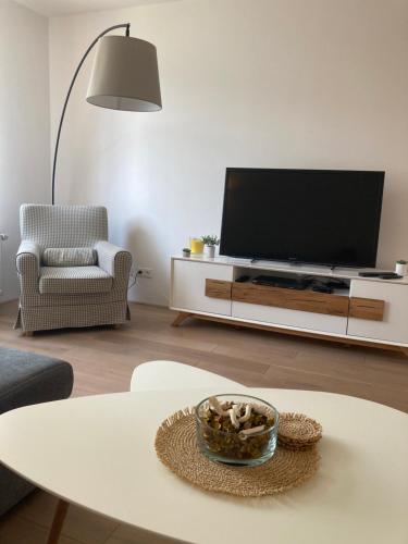 a living room with a flat screen tv on a entertainment center at Ústí nad Labem, Apartmány pod hradem Střekovem in Ústí nad Labem