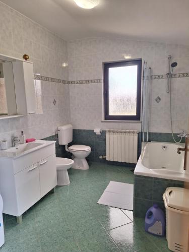 a bathroom with two toilets and a sink and a shower at Apartment Katarina in Vodnjan