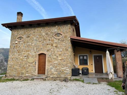 a small brick building with a porch and a door at Casa vacanze La Cascina di Caterina in Castellabate