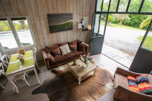 a living room with a couch and a table at Erreka Txikia in Urrugne