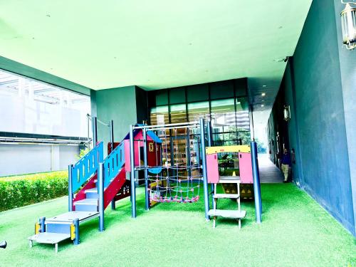a playground with a colorful slide in a building at Star Residence Suite KLCC in Kuala Lumpur