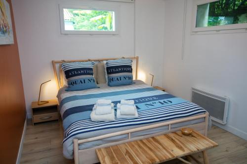 a bedroom with a bed with blue and white stripes at Erreka Txikia in Urrugne