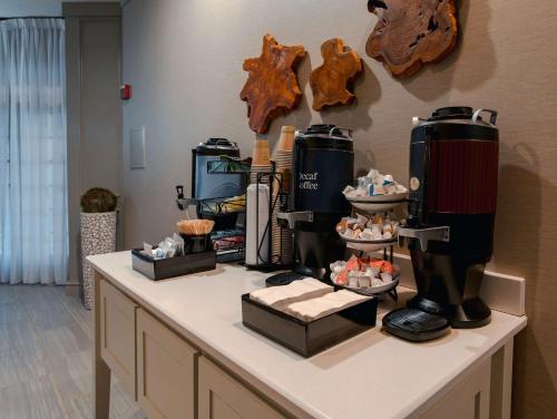 a table with a coffee maker and cupcakes on it at Homewood Suites by Hilton Ft. Worth-Bedford in Bedford