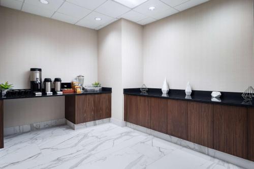 a lobby of a hotel with a counter and a coffee shop at Embassy Suites Huntsville in Huntsville