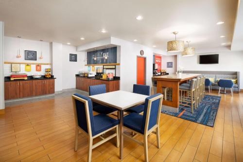 a dining room and kitchen with a table and chairs at Hampton Inn Sacramento/Rancho Cordova in Rancho Cordova