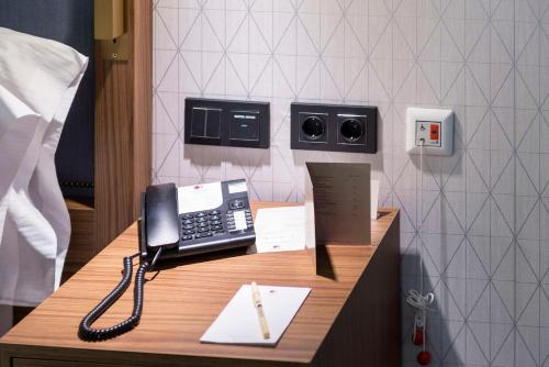 a phone on a desk in a hotel room at DoubleTree by Hilton Madrid-Prado in Madrid
