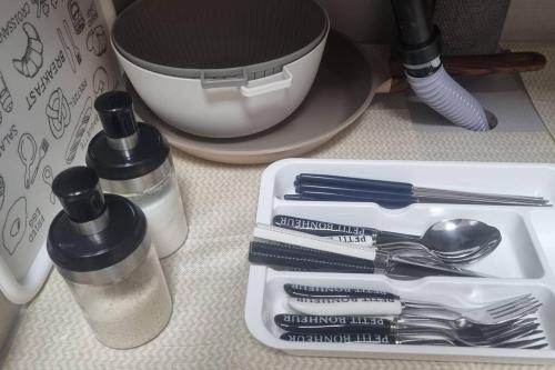 a white tray with silver utensils on a counter at Holiday Gwangju in Gwangju