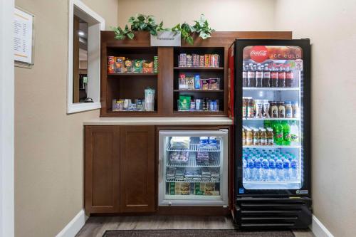 a refrigerator with its door open in a room at Comfort Suites in Tulare