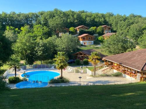 an aerial view of a house with a swimming pool at LES REFUGES DU LOT Kouki's Lodge in Mauroux