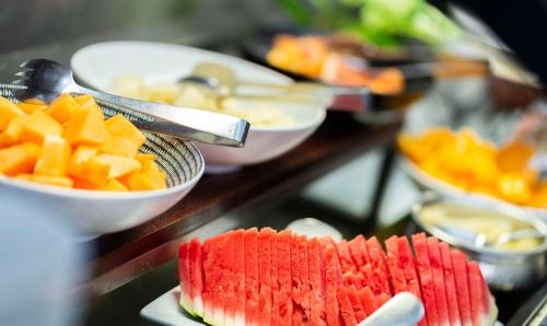 a buffet of food with fruit on a table at Rydges Esplanade Resort Cairns in Cairns