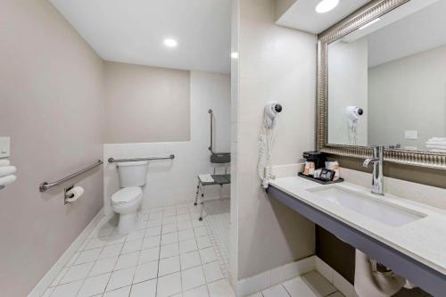 a bathroom with a toilet and a sink and a mirror at Quality Inn Kettleman City near Hwy 41 in Kettleman City