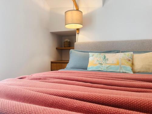 a bedroom with a bed with a red blanket at Tzane Luxury Suites - Luxury Suites in the City Center for Comfort & Privacy By Villa Mana Gers in Zakynthos Town