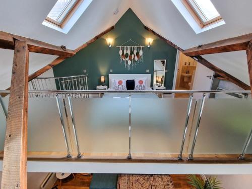 a loft conversion with a dining area in a house at Luxury Piccadilly Duplex Flat by City SuperHost in Manchester