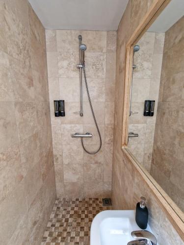 a bathroom with a shower and a sink at Luxury Piccadilly Duplex Flat by City SuperHost in Manchester