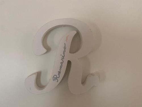 a sign that says ra hanging on a wall at Finale Ligure Gorra Rooms Rosa di Mare vicino al mare lontano dal caos! in Borgio Verezzi