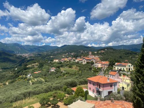 a town on a hill with mountains in the background at Finale Ligure Gorra Rooms Rosa di Mare vicino al mare lontano dal caos! in Borgio Verezzi