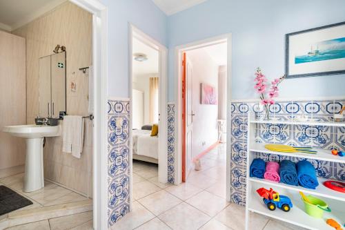 a bathroom with a sink and a bathroom with a toilet at Apartamentos Casal Ventoso in Pedrógão