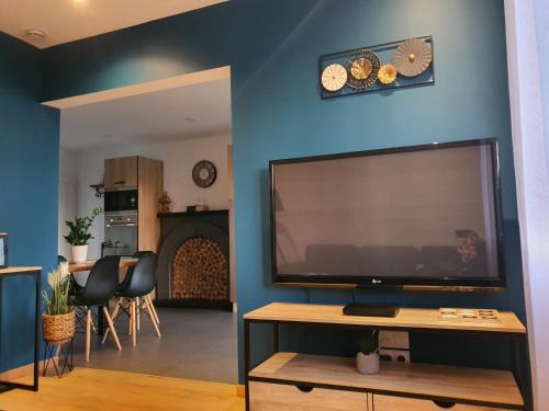 a living room with a large flat screen tv at GITE EN CAMPAGNE 15 min de Rennes in Saint-Gilles