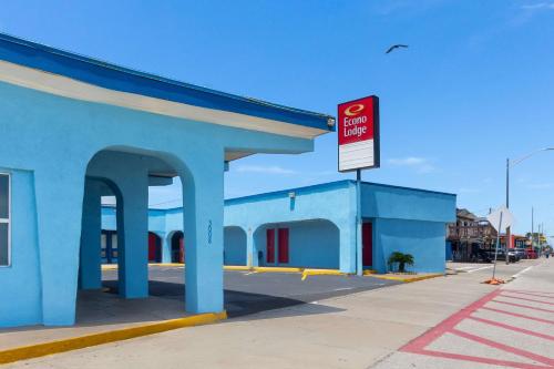 a blue building with a no parking sign in front of it at Econo Lodge Galveston Seawall in Galveston