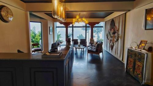 a living room with a kitchen and a dining room at Pema Thang Guest House Mcleodganj in Dharamshala