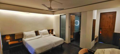 a bedroom with a bed and a ceiling fan at Pema Thang Guest House Mcleodganj in Dharamshala
