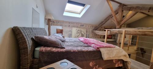 a small bedroom with a bed in a attic at O Beaujolais Chiroubles in Chiroubles