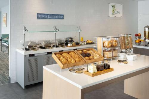 a kitchen with a counter with lots of food on it at DoubleTree by Hilton Miami North I-95 in Miami