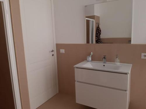 a bathroom with a white sink and a mirror at A 20 passi dal mare in Giardini Naxos