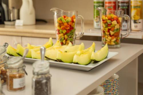 a plate of fruit on a counter in a kitchen at Hotel Vecchia Marina in Àrbatax