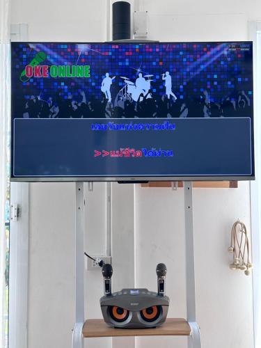 a tv screen on a stand with a vince online machine at Maryland Khaoyai Annapolis Pool Villa in Ban Nong Song Hong