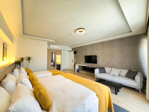 a bedroom with a large bed and a living room at Dugi Hotel in Istanbul
