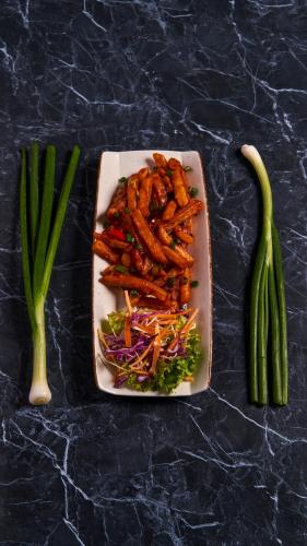a plate of food with vegetables on a table at Pema Thang Guest House Mcleodganj in Dharamshala