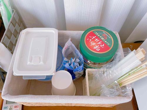 a lunch box with food and other items in it at T&T Fujiyama Guest House in Fujiyoshida