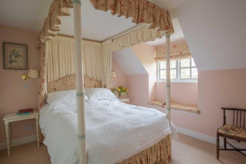 En eller flere senge i et værelse på Cheltenham Cottage