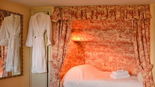 En eller flere senge i et værelse på Cheltenham Cottage