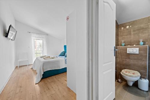 a white room with a bed and a toilet at Five bedroom villa Emily with pool in Medulin in Medulin