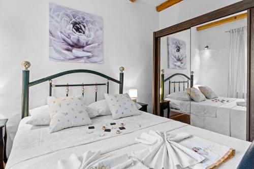 a bedroom with two beds with white sheets and pillows at Five bedroom villa Emily with pool in Medulin in Medulin