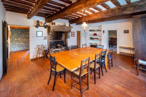 a large dining room with a wooden table and chairs at Verde Immenso - Pool BBQ Relax in Molino Abbadia
