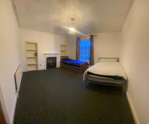 a bedroom with a bed and a fireplace at Southgate Lodge - Single-Twin, Double and Family rooms in Kings Lynn