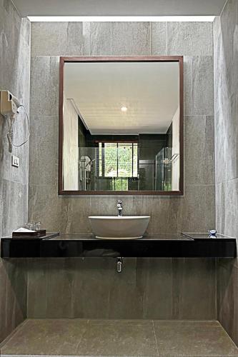 a bathroom with a sink and a large mirror at Eco Inn Cottage by Aonang Hill in Ao Nang Beach