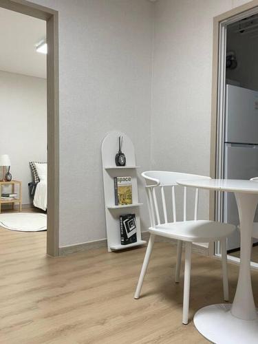 a kitchen with a white table and a white chair at Draw Gwangju in Gwangju