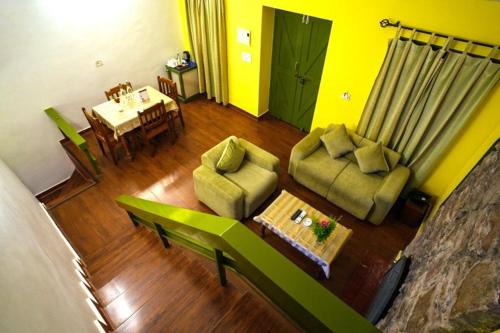 a living room with a couch and chairs and a table at Mountain Club Resort Munnar in Chinnakanal