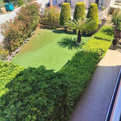 a garden with green plants and a walkway at Aithrea's HOMES in Pastida Rhodes in Pastida