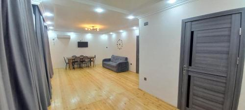 a room with a table and a chair and a door at Rovshan's house in Sheki