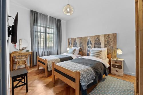 a bedroom with two beds and a table and a chair at Family retreat House Begonija with pool and BBQ in Burići