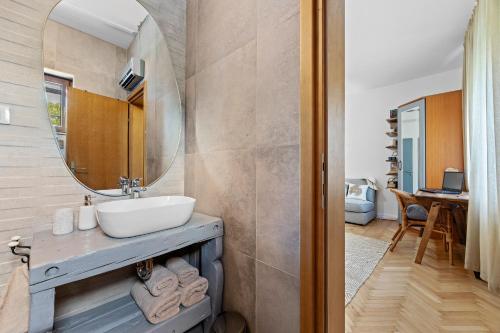 a bathroom with a sink and a mirror at Family retreat House Begonija with pool and BBQ in Burići
