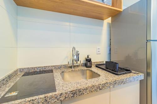 a kitchen counter with a sink and a microwave at Allure Residence by Carpediem in Recife